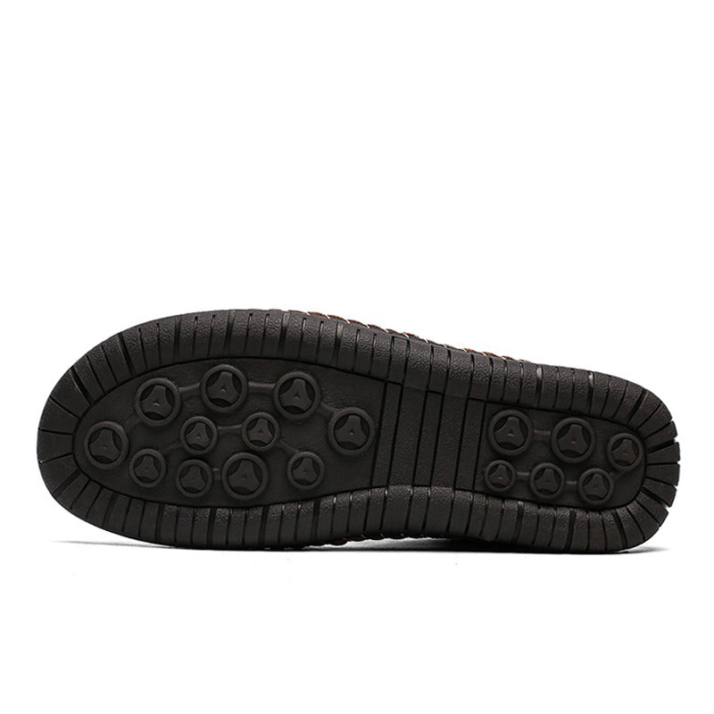 Bottom view of men's ankle boots showcasing the rubber sole with grip patterns for traction and comfort.