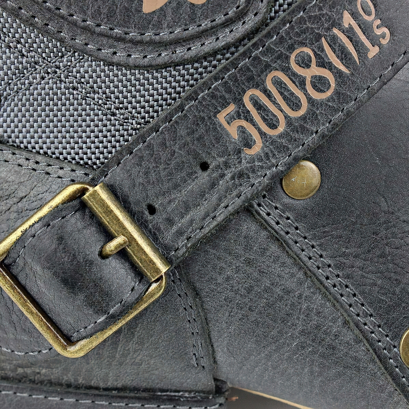 Close-up of men's genuine leather boot strap with buckle detailing, showcasing stylish black rock fashion.