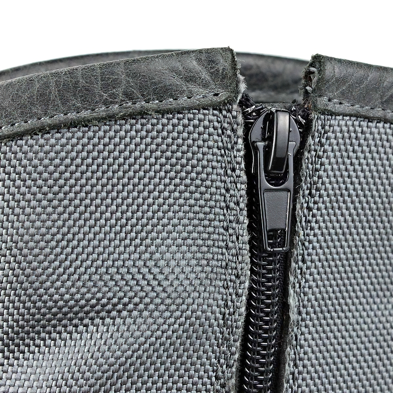 Close-up of the zipper detail on stylish men's casual leather boots in rock style.