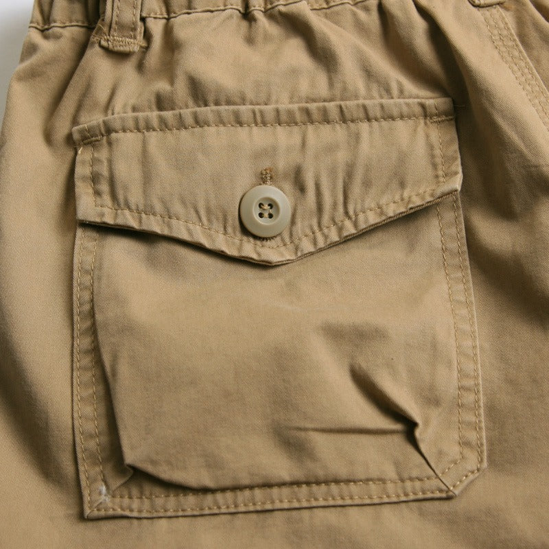 Close-up of a stylish men's cotton capri short pocket with button detail in khaki.