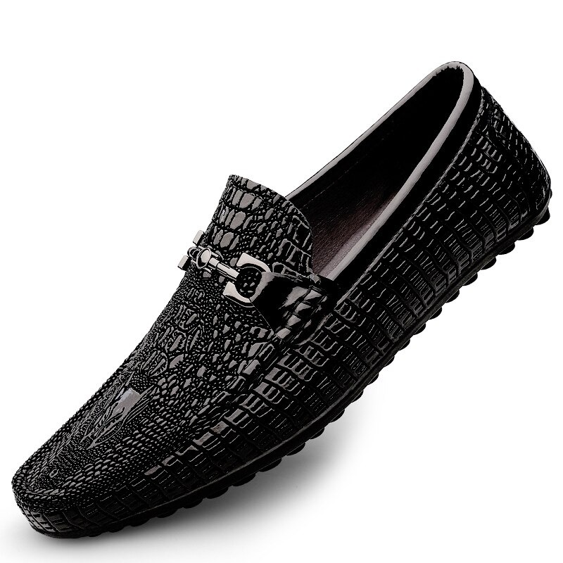 Black leather loafers with crocodile texture and stylish silver buckle, perfect for fashionable men's outfits.