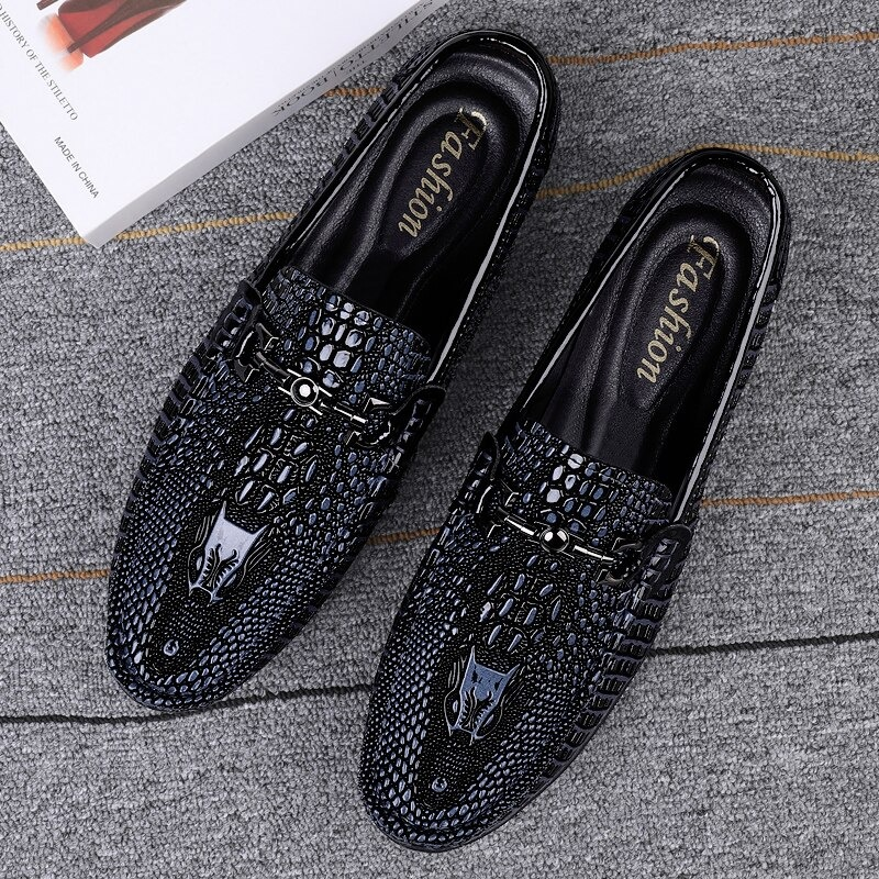 Stylish black leather loafers with crocodile print, perfect for versatile fashion looks and comfort.