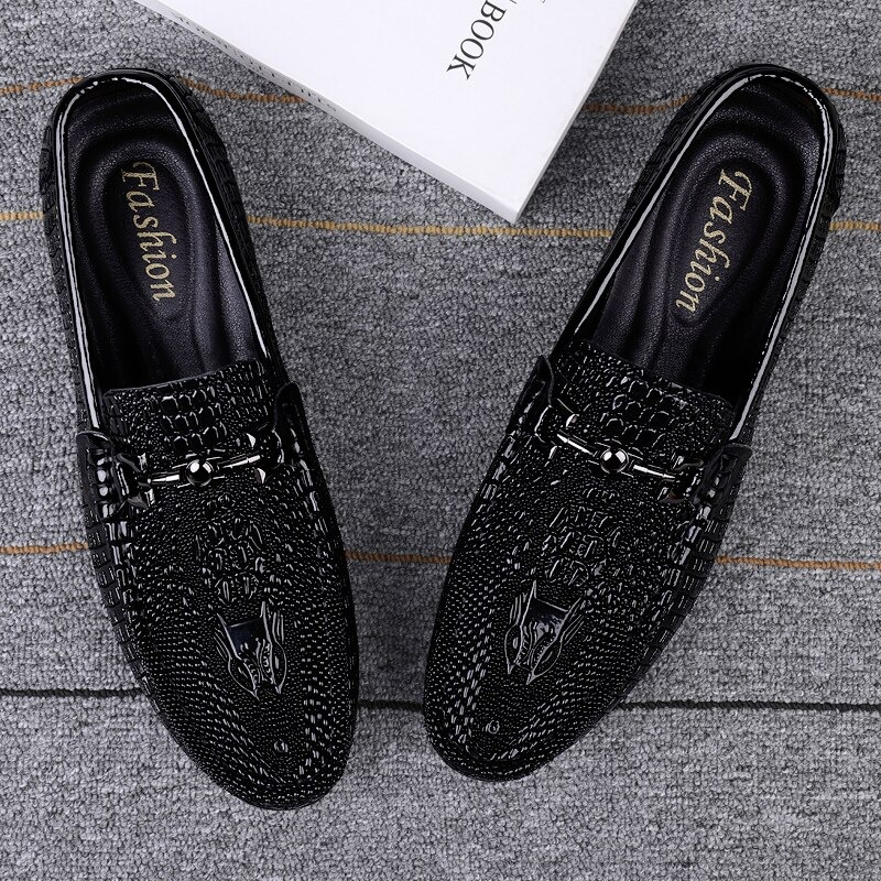 Black gothic leather loafers featuring a sleek design and breathable texture, perfect for stylish comfort.