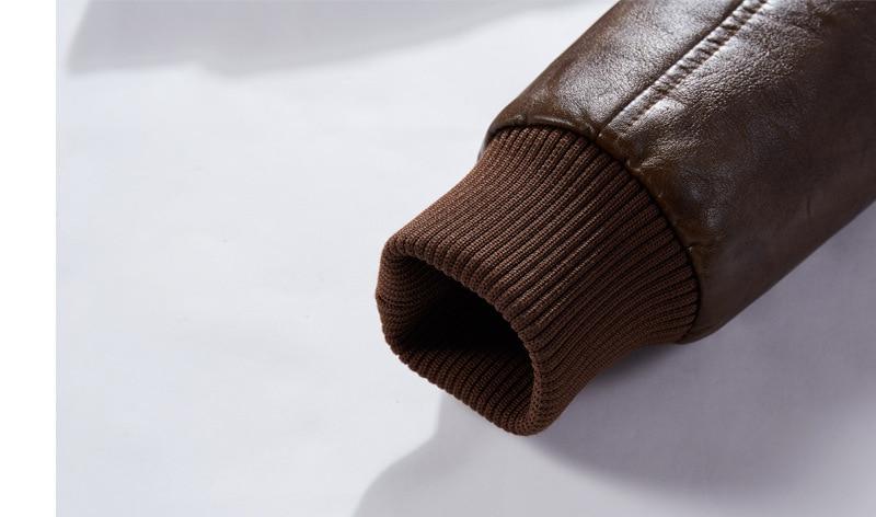 Close-up of a brown leather motorcycle jacket sleeve featuring ribbed cuff for a snug fit.
