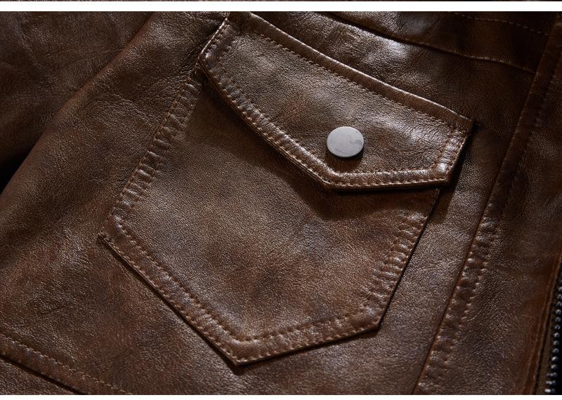 Close-up of a men's motorcycle leather jacket pocket with decorative stitching and a snap button.