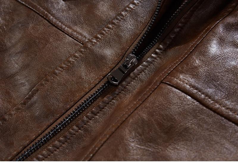 Close-up of a brown motorcycle leather jacket showing high-quality zipper detail and textured faux leather.