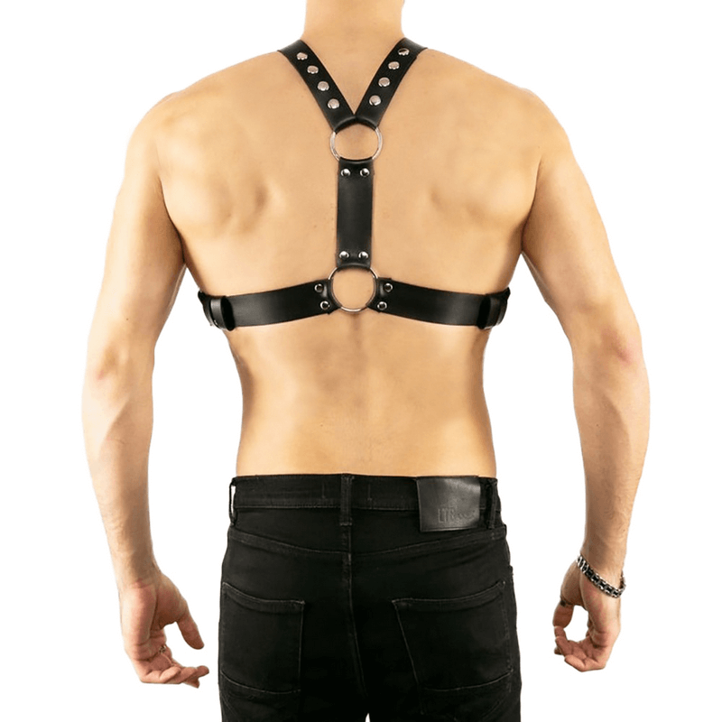 Men's adjustable black chest harness with rivet details on model's back, showcasing punk style and quality materials.
