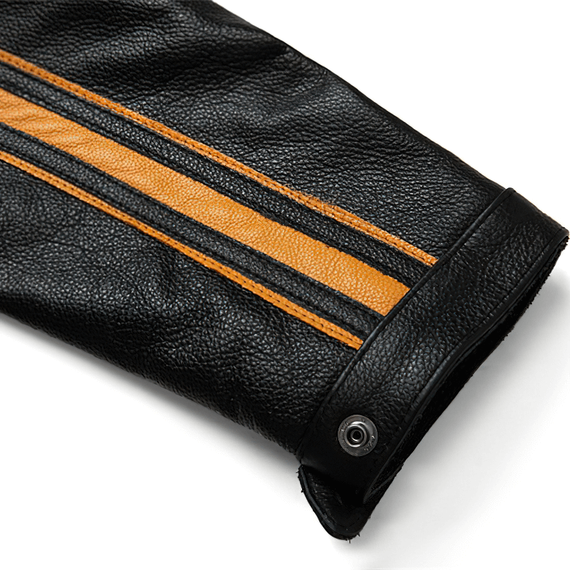 Close-up of a black leather jacket sleeve featuring stylish orange stripes and snap button detail.