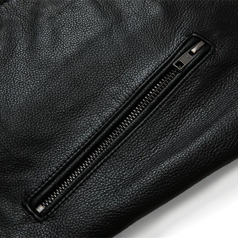 Close-up of a black genuine leather jacket zipper, showcasing its high-quality material and rock-style design.