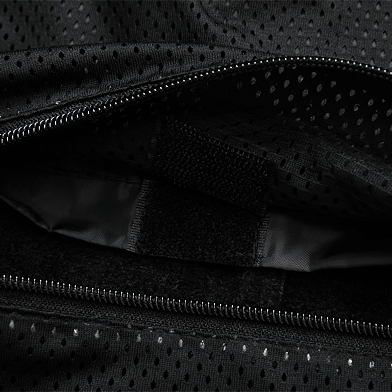 Close-up of the interior pocket of a men's black leather jacket with black mesh lining and velcro closure.