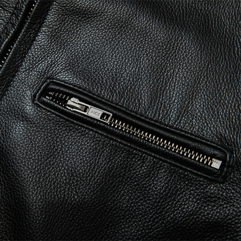 Close-up of the zipper on a men's black genuine leather motorcycle jacket, showcasing its quality and stylish design.