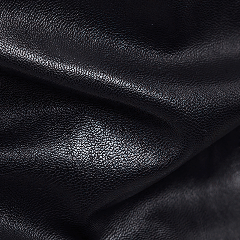 Close-up of black PU leather texture showcasing its quality and finish, ideal for trendy jackets.