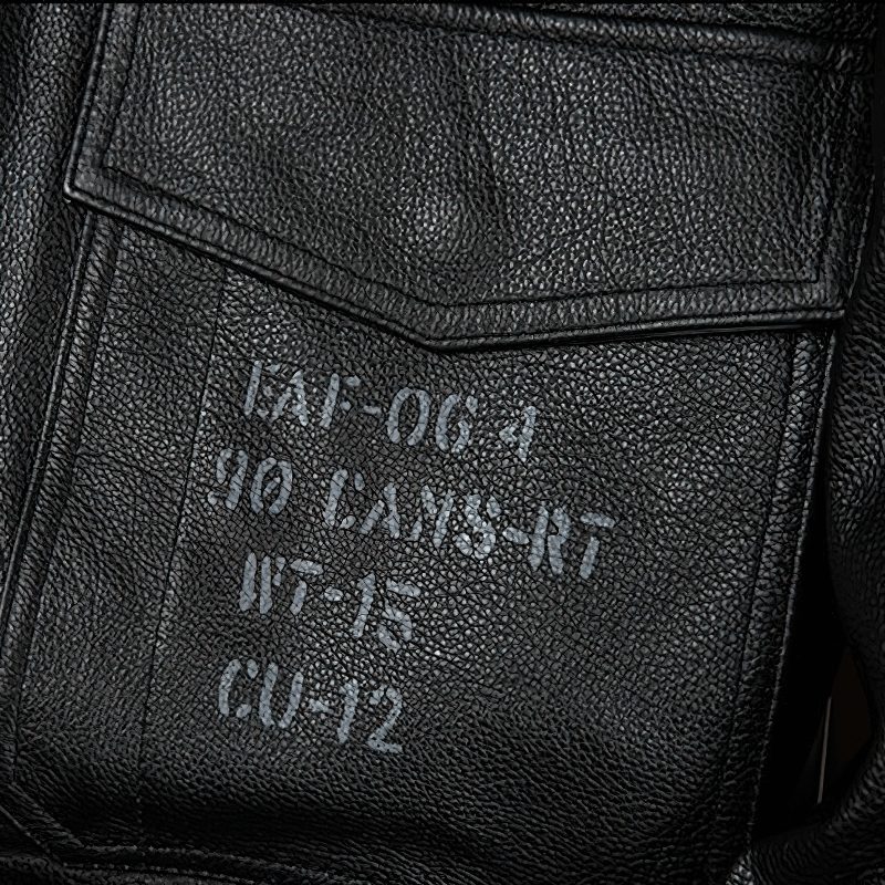 Close-up of the inner label of a black genuine leather motorcycle jacket showing size and care instructions.