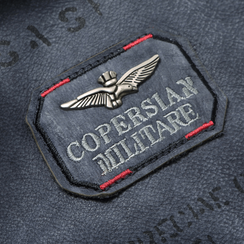 Close-up of Copersian Military badge embroidered on dark leather fabric.