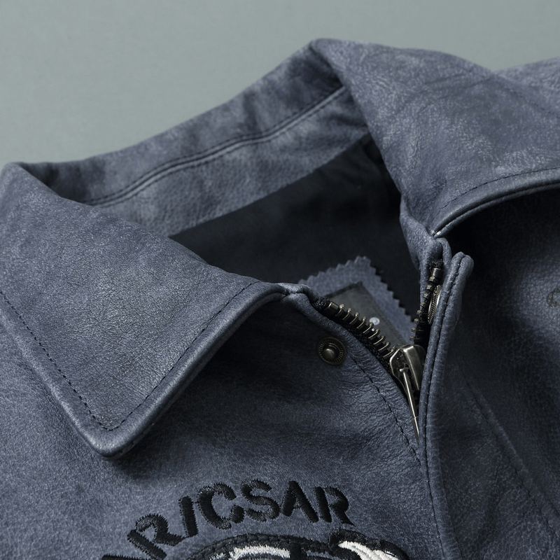 Close-up of a men's genuine leather motorcycle jacket collar and zipper detail.