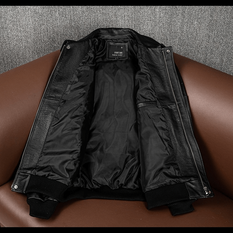 Interior view of a men's genuine leather motorcycle jacket, featuring spacious pockets and a sleek black lining.