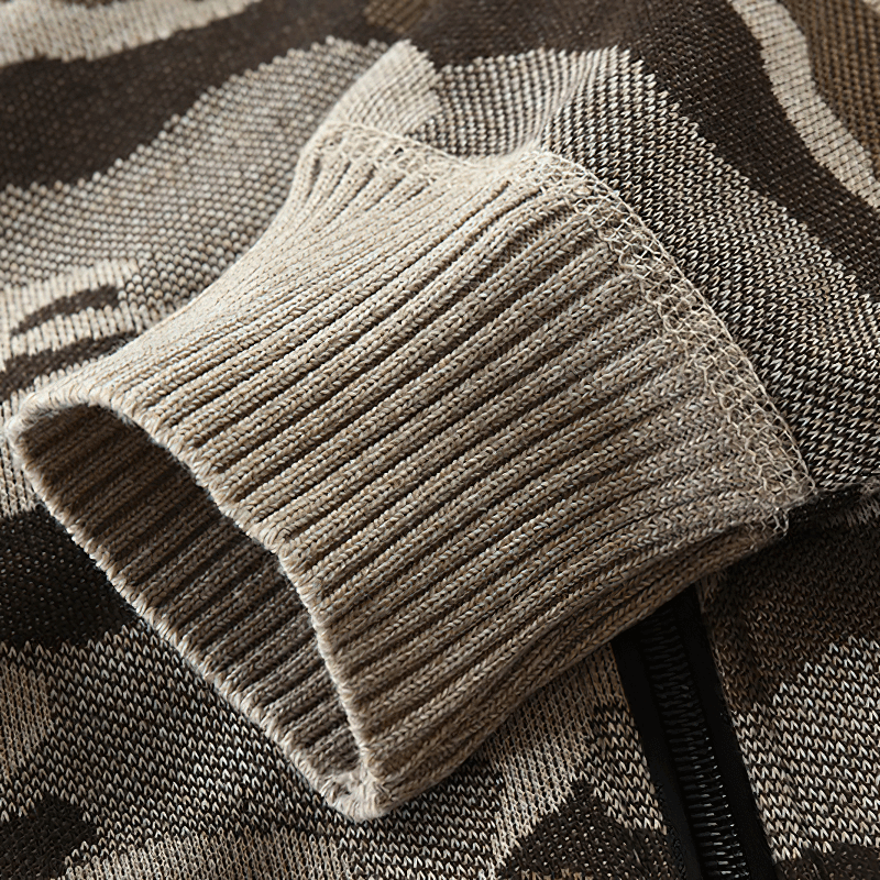 Close-up of the ribbed cuff on a men's camouflage hooded cardigan sweater in warm knitting fabric.