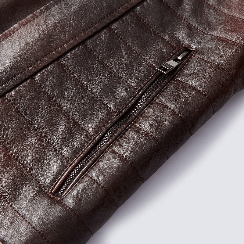 Close-up of a brown leather jacket pocket with zipper detail, showcasing quality craftsmanship and stylish design.