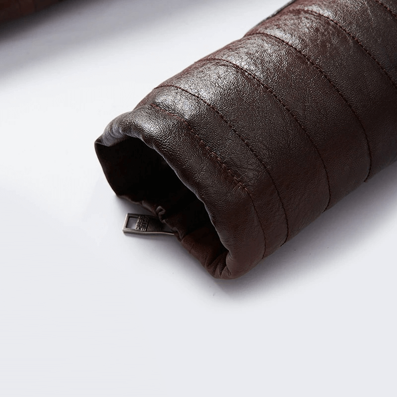 Close-up of a brown leather jacket sleeve with quilted texture and zipper detail, showcasing warmth and style.