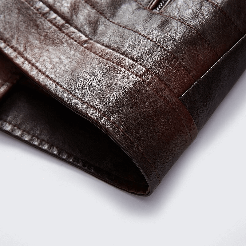 Close-up of a brown leather jacket sleeve showcasing its texture and zipper detail, part of men's fur collar outerwear.