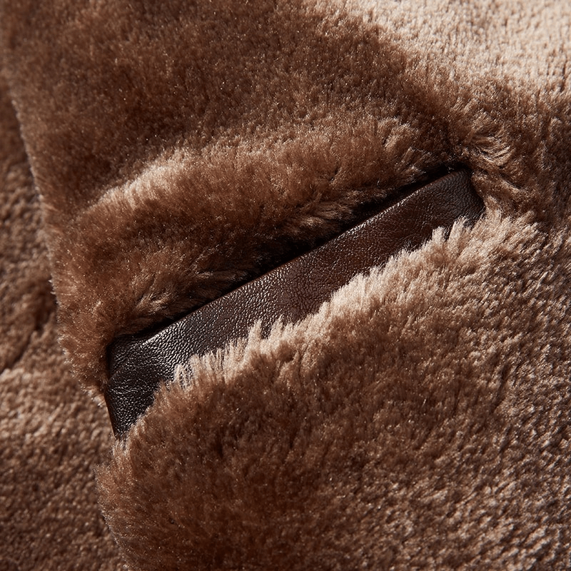 Close-up of a warm men's leather jacket featuring a brown fur collar and hidden side pocket.