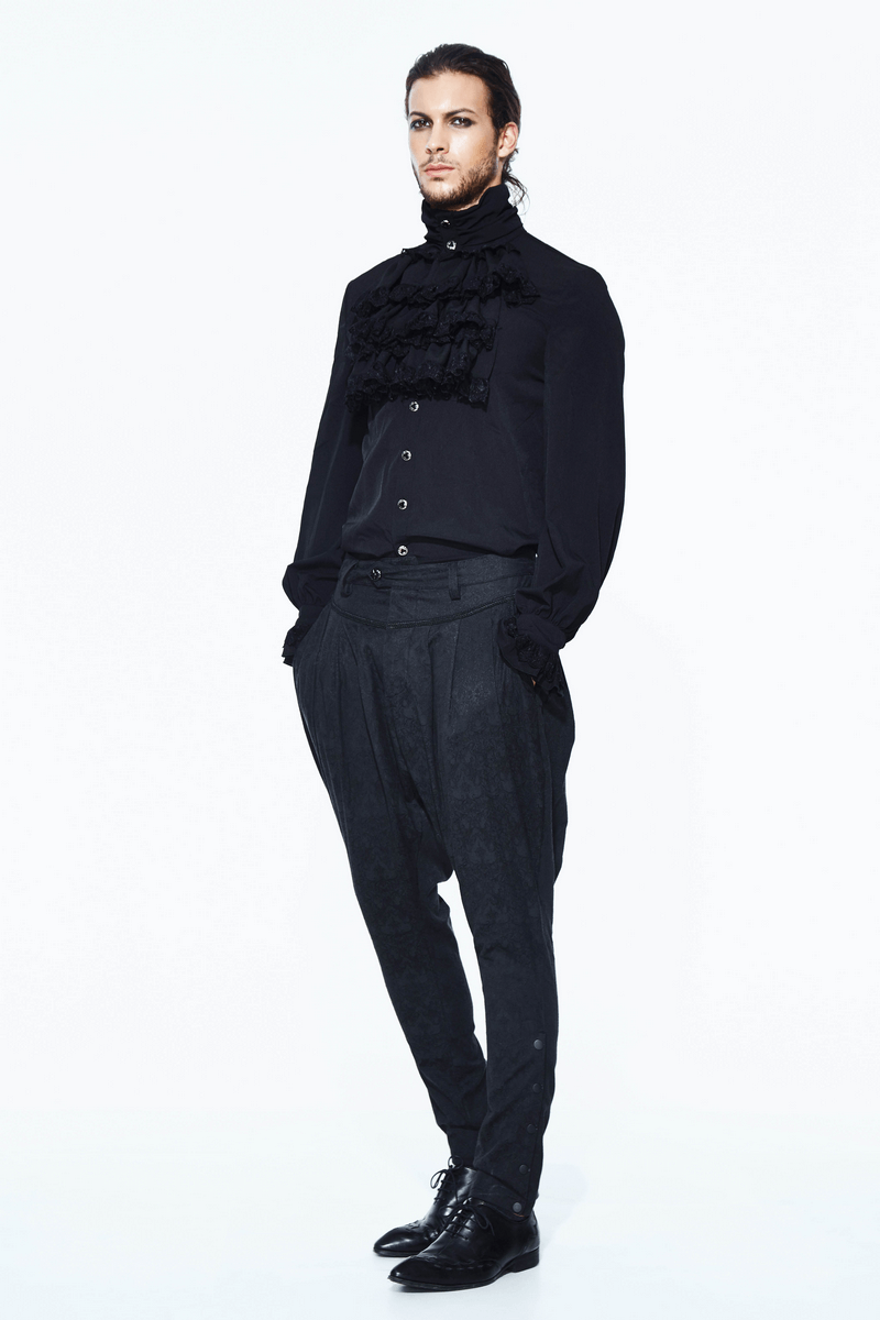 Men's goth fashion featuring a black ruffled shirt and stylish tapered pants, perfect for an edgy wardrobe.