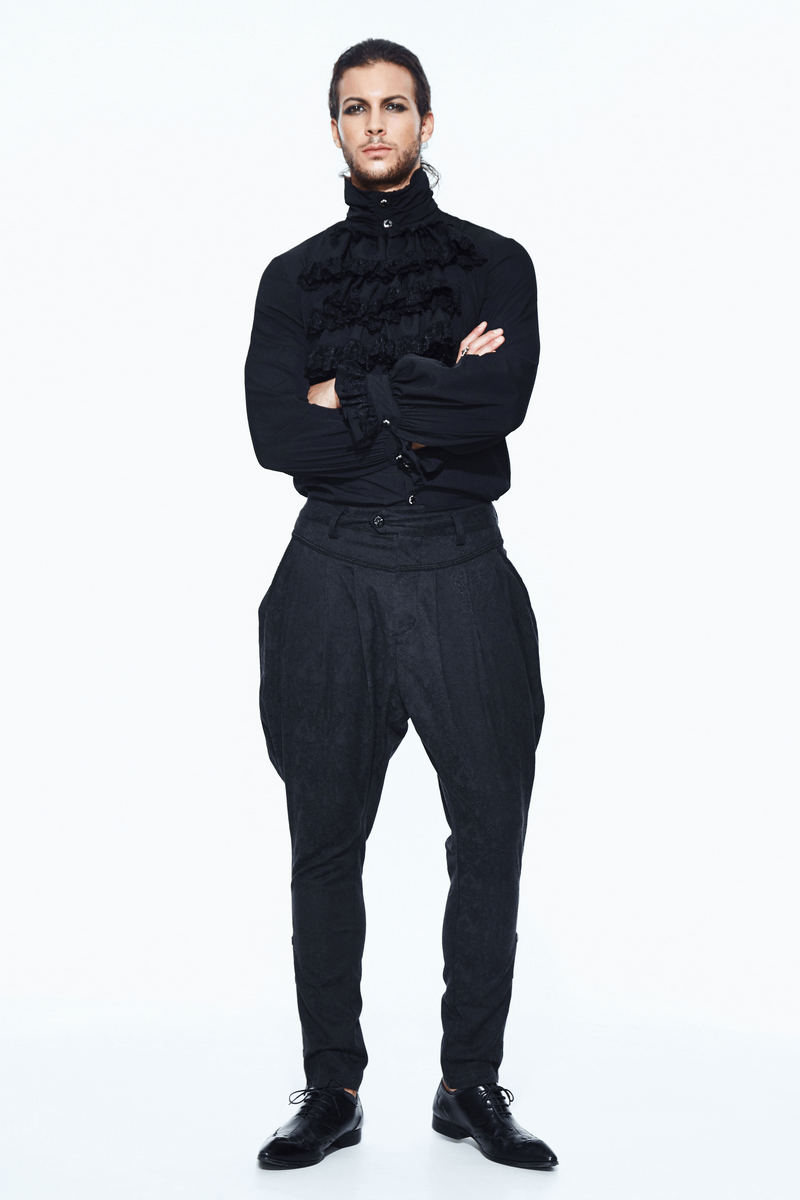 Stylish man in black gothic shirt and baggy pants, showcasing a sophisticated gothic fashion look.