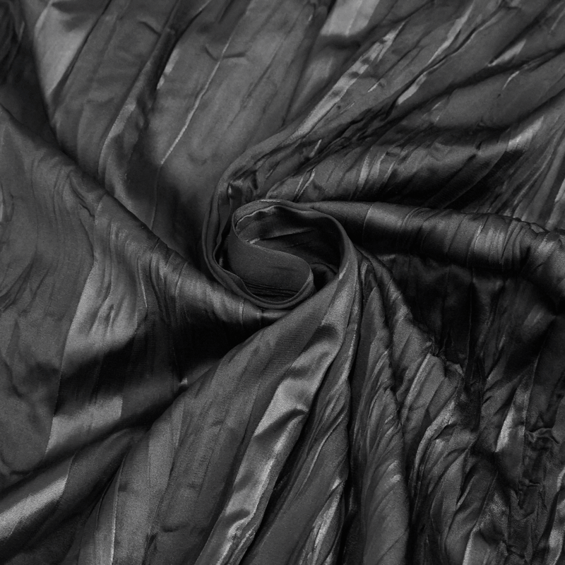 Black textured fabric showcasing delicate folds, ideal for gothic fashion creations.