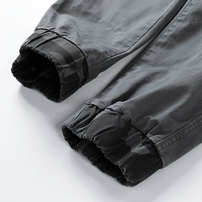 Close-up of men's joggers with camouflage elastic cuffs, showcasing trendy casual style for streetwear.