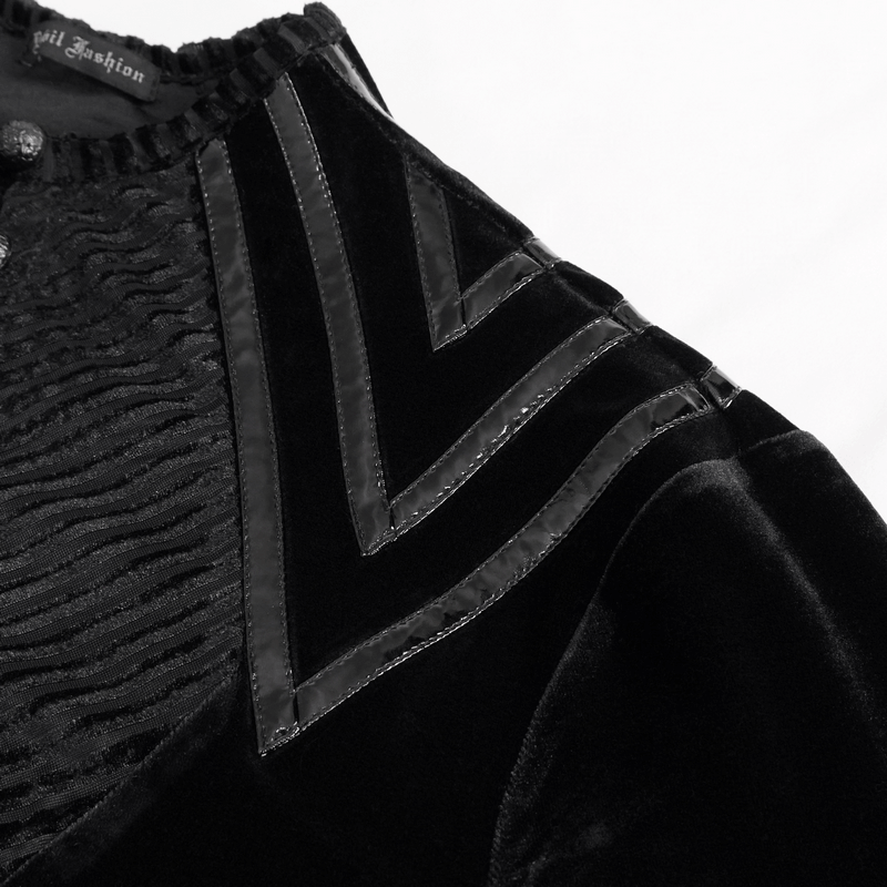 Close-up of men's black velvet top with leather strips detail and buttoned accents for gothic style fashion.