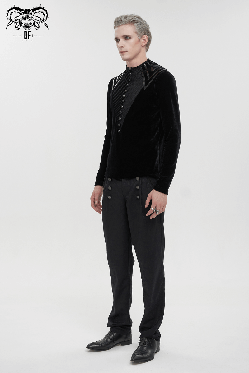 Men's gothic style black velvet long sleeve top with leather strips and button accents, paired with black trousers and stylish shoes.