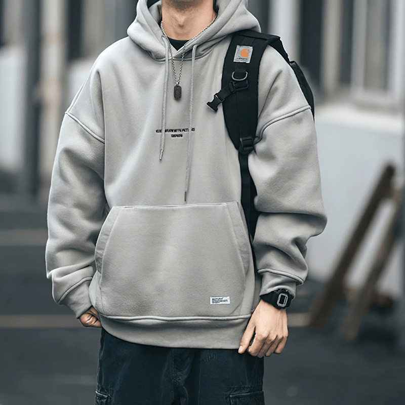 Men's gray fleece hoodie with drawstring and loose fit, perfect for alternative style outfits.