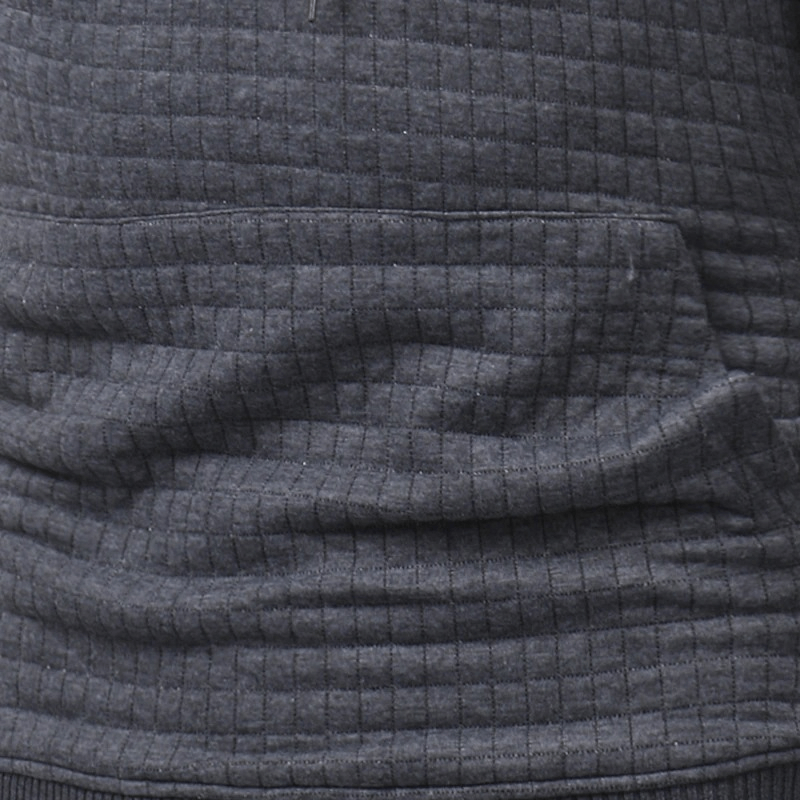 Close-up of textured dark gray men's long sleeve hoodie showcasing cozy fabric and stylish pocket detail.