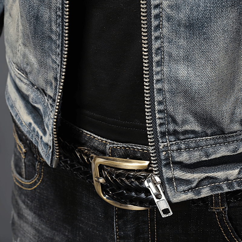 Close-up of a men's motorcycle zipper denim jacket paired with a braided belt, showcasing trendy outerwear style.