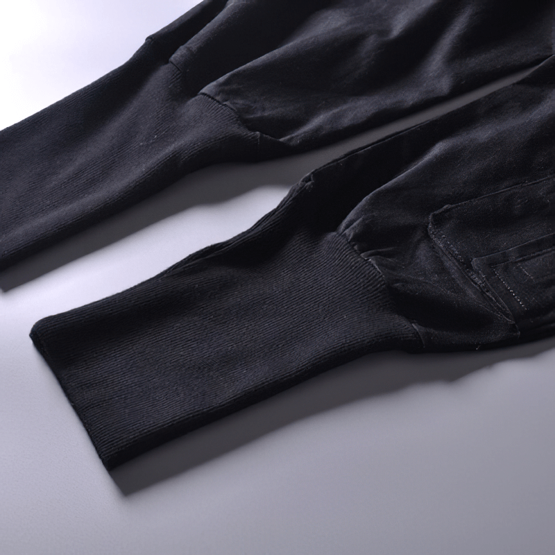 Close-up view of men's black cargo joggers showcasing the multi-pocket design and stylish ribbed cuffs.