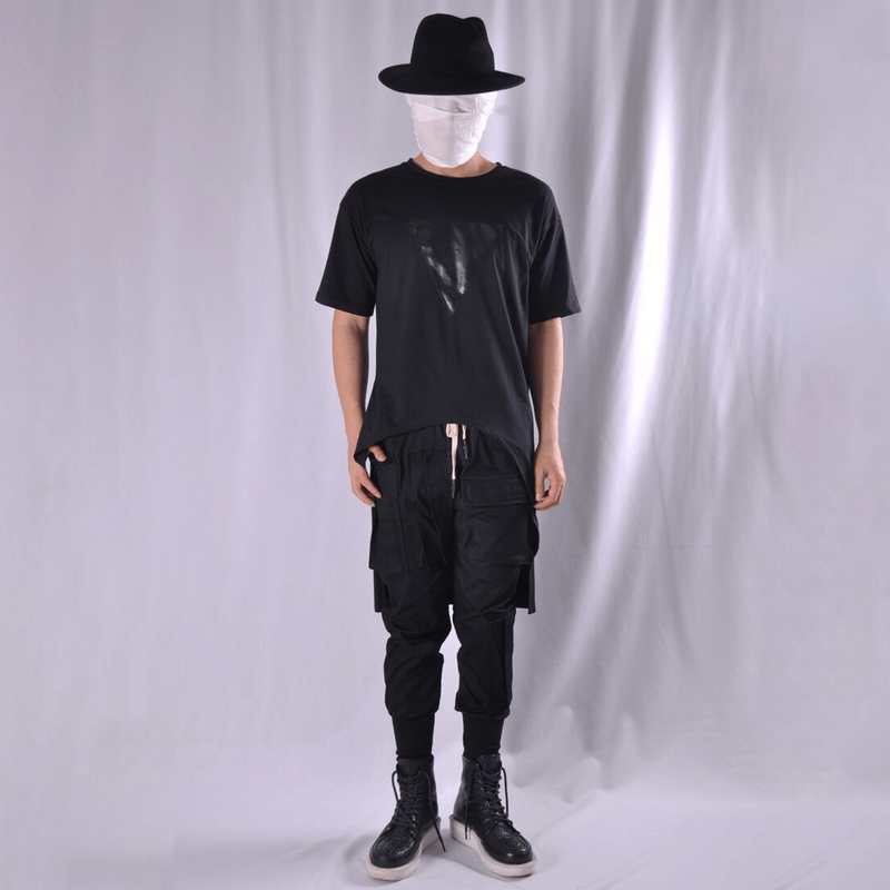 Stylish model wearing men's multi-pocket black cargo joggers and a black tee, showcasing alternative fashion.
