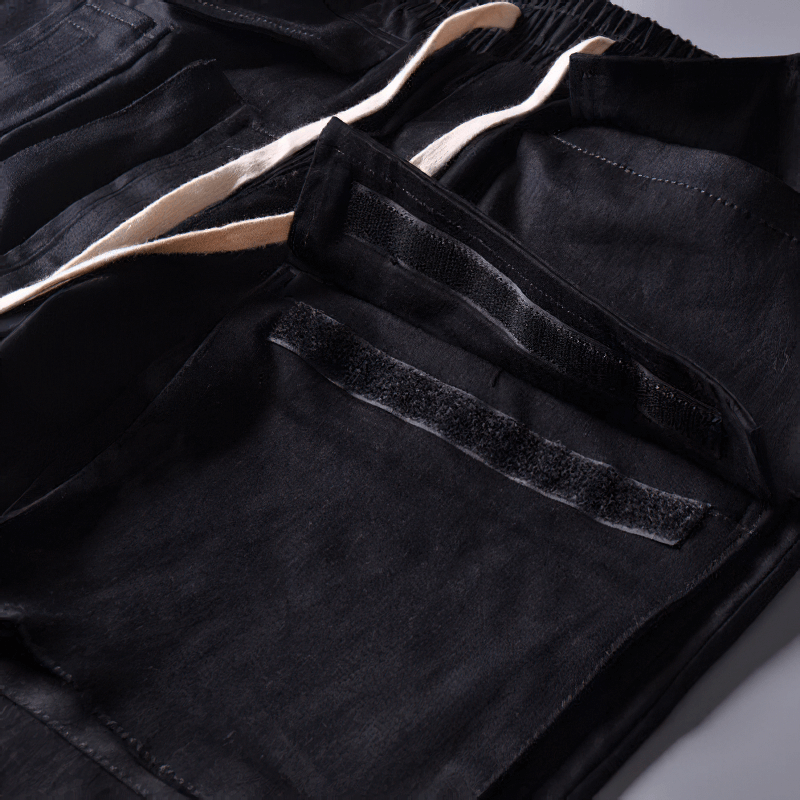 Close-up of men's black cargo joggers showing multi-pocket design for functionality and style.