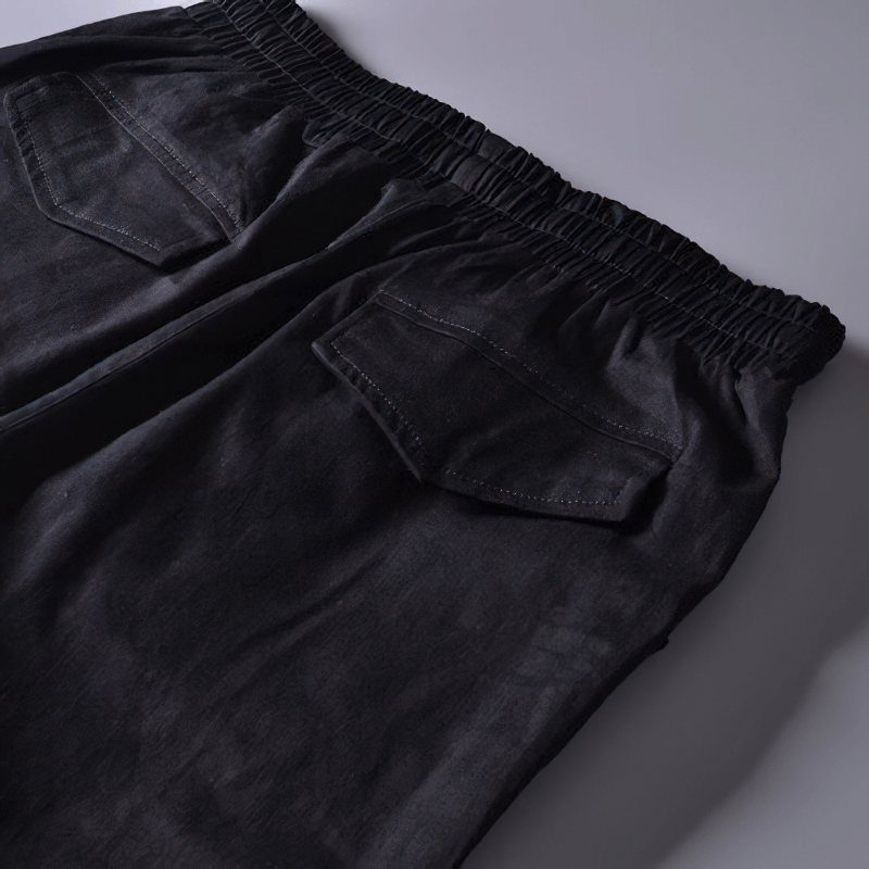 Back view of men's black cargo joggers showcasing multi-pocket design and elastic waistband for comfort.