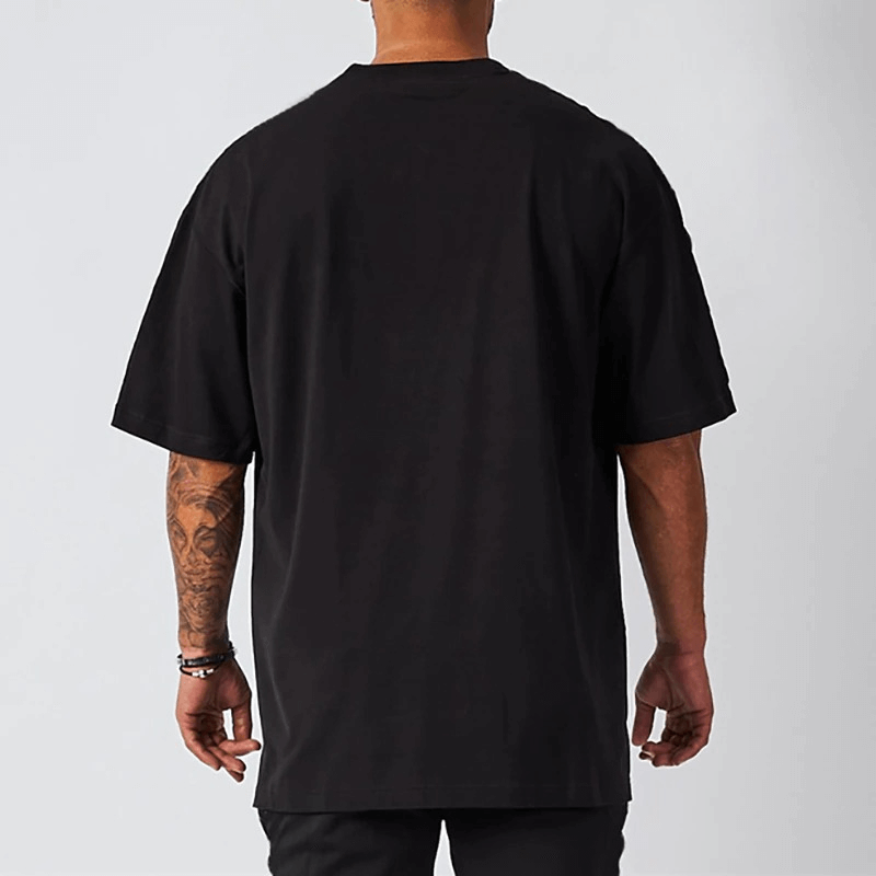 Back view of a men's oversized black short sleeve t-shirt with dropped shoulder for casual wear.