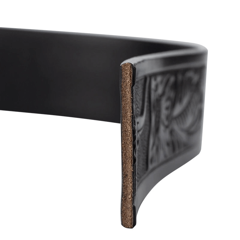 Close-up of a men's vintage leather belt showcasing detailed pattern and quality craftsmanship in black.