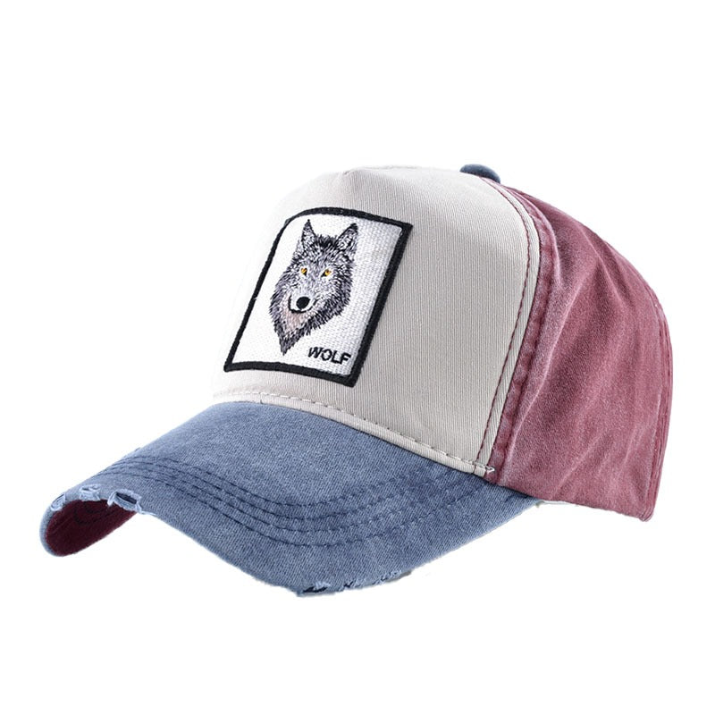 Unisex snapback baseball cap featuring wolf embroidery, in washed denim with multicolored design.