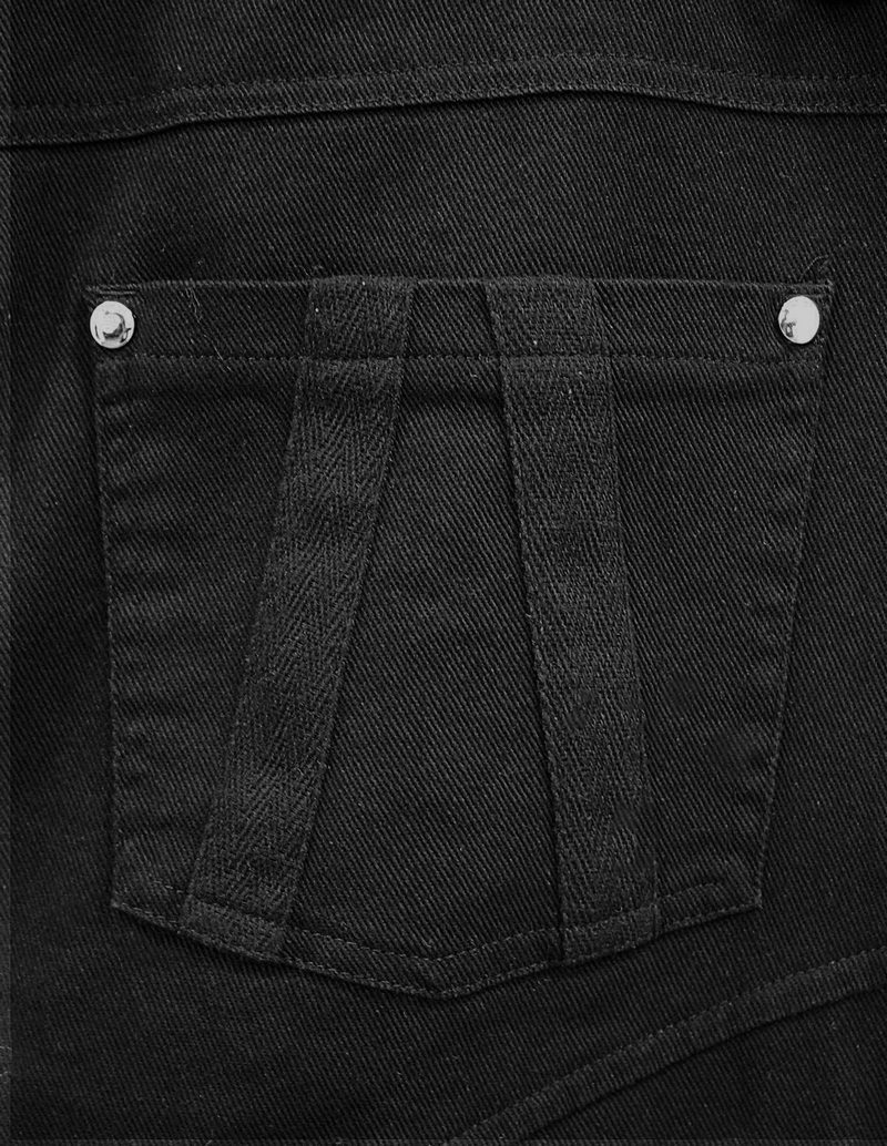 Detail of men's black punk pants featuring a stylish pocket design with silver buttons and unique stitching.