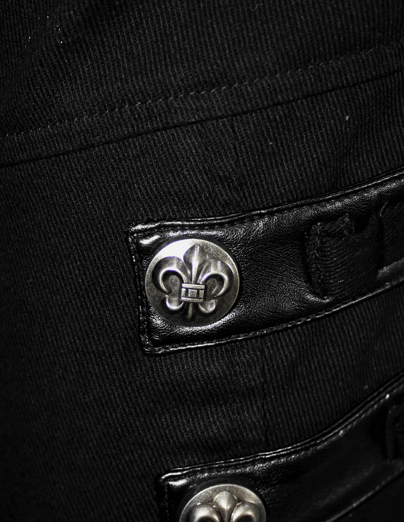 Close-up of black punk pants featuring silver studs and buckles for a stylish edgy look.