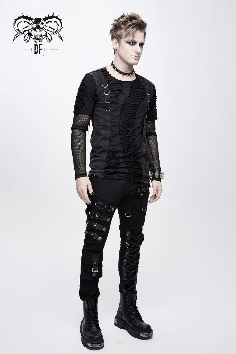 Stylish man in punk black outfit, featuring laced pants, studded details, and a trendy textured shirt.