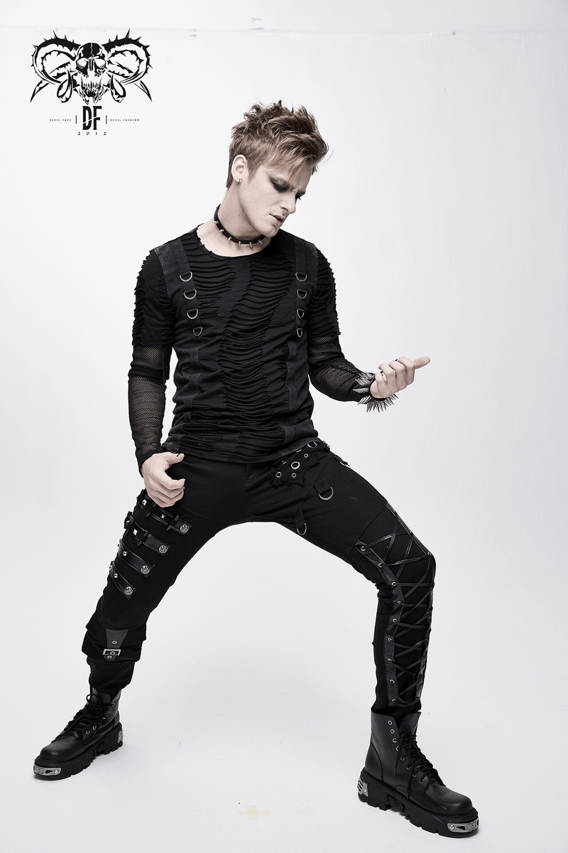 Men's black punk fashion model wearing asymmetric pants with lacing, studs, and buckles, showcasing edgy style.