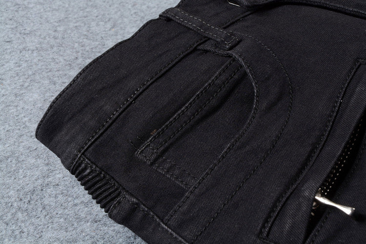 Close-up of stylish men's black biker jeans showcasing pockets and stitching details, perfect for goth and rock fashion.