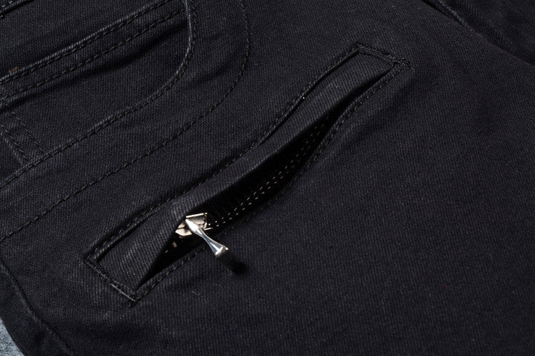 Close-up of men's black biker jeans featuring a stylish zip pocket, perfect for goth and rock fashion enthusiasts.