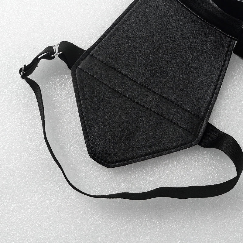 Close-up of a men's faux leather body harness strap with adjustable buckles and O-ring details.