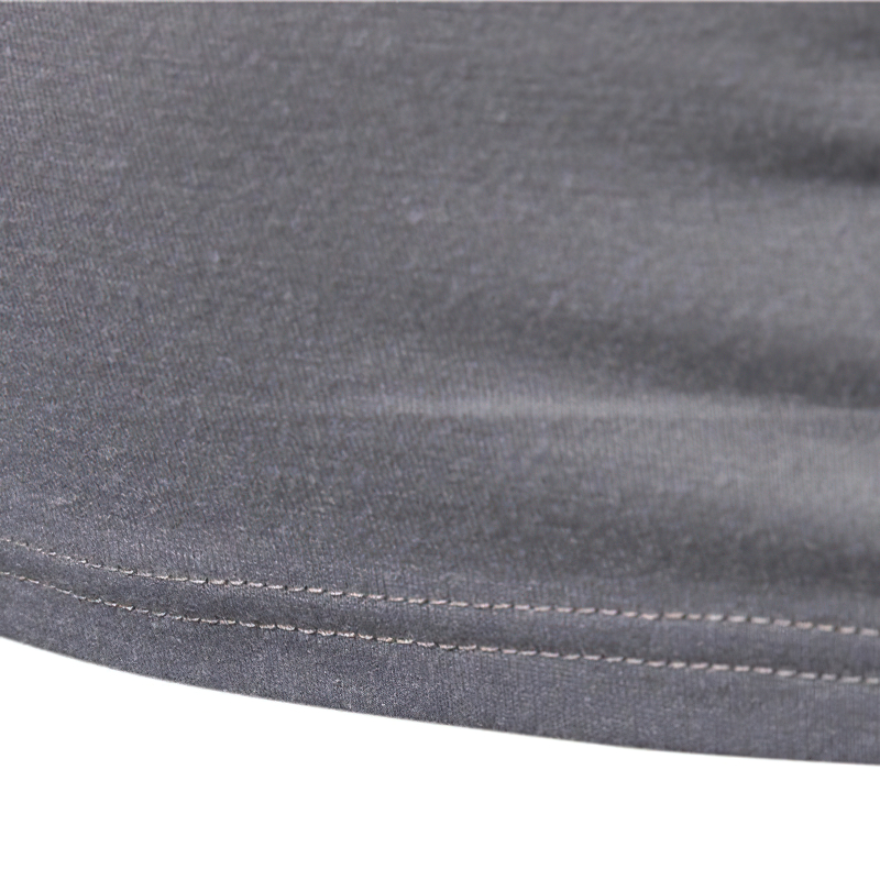 Close-up of the hem detailing on a men's camouflage tactical military sweatshirt, showcasing quality stitching.