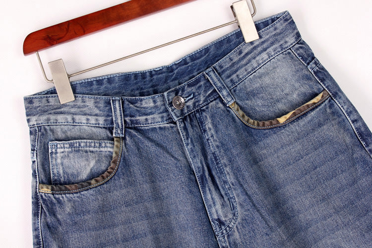 Men's loose denim cargo shorts showcasing a blue wash and practical pockets, perfect for streetwear style.